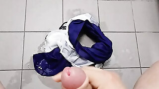 Teenager pops on his swimming trunks in swimming pool locker room